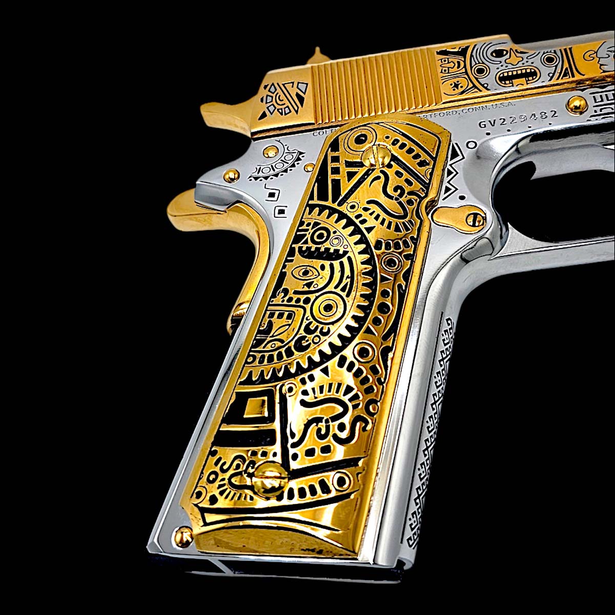"Close-up of Mayan Calendar design engraved on 24K gold-plated aluminum 1911 grips."


