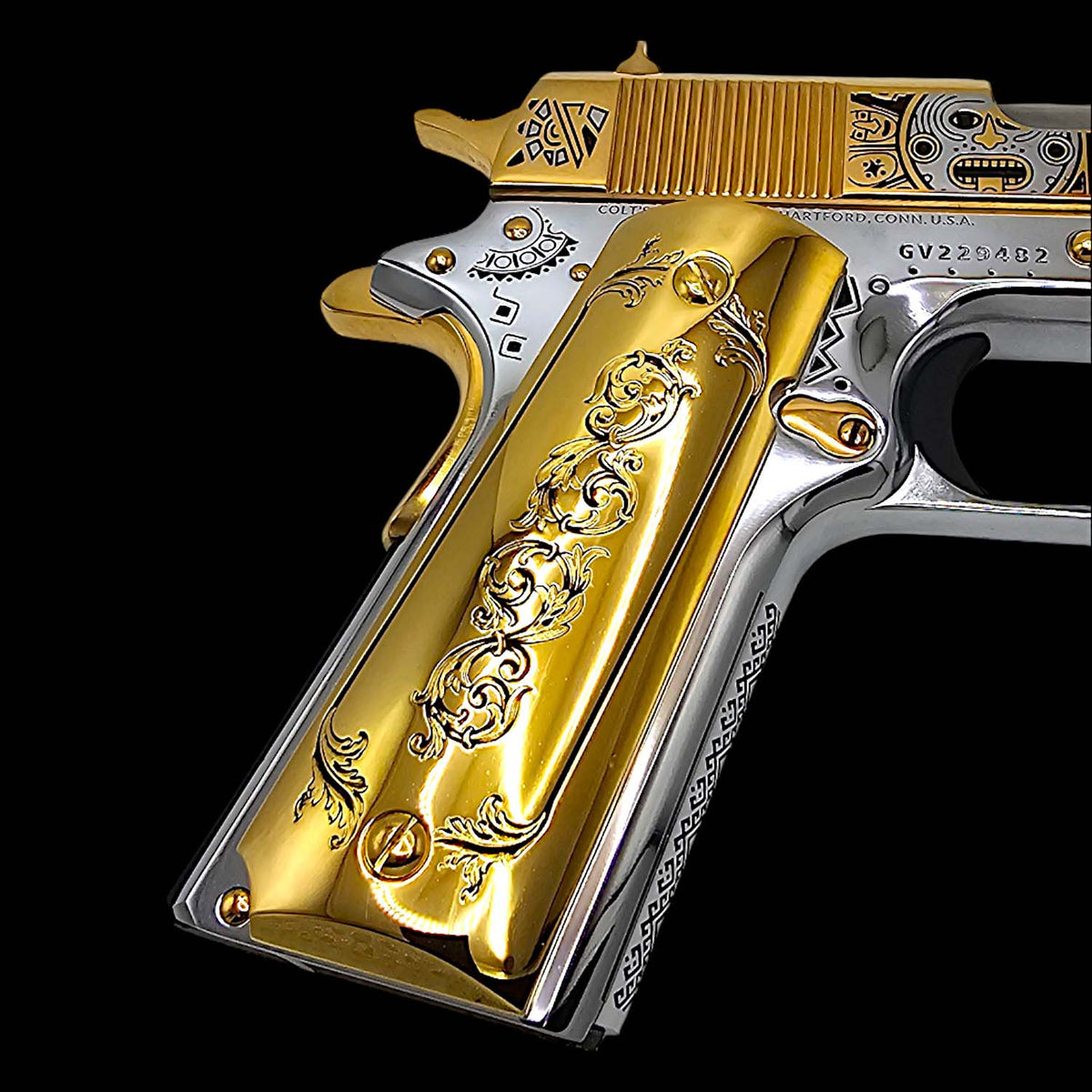 Close-up of engraved filigree scroll on gold plated 1911 pistol grip

