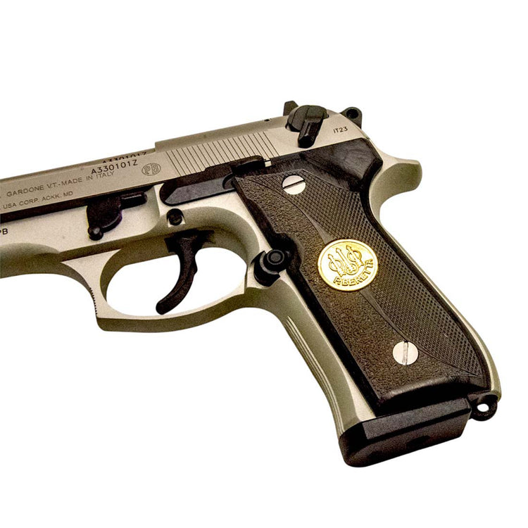 Close-up of Beretta medallion in ebony pistol grip